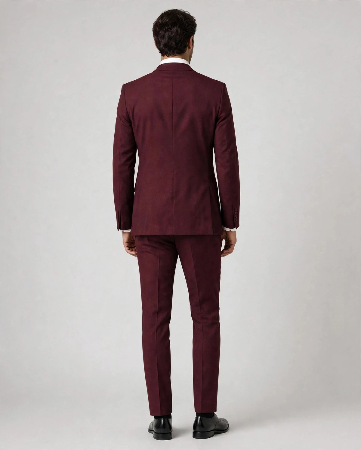 Burgundy men's three-piece suit — back view on model